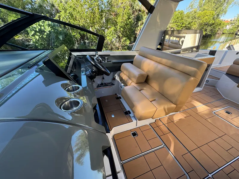 Slide: The Image of 2022 Aviara AV36 OB boat interior with tan seating and modern dashboard. - 14