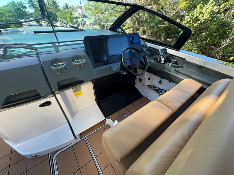 Slide: The Image of 2022 Aviara AV36 OB boat cockpit with modern controls and beige seating. - 15