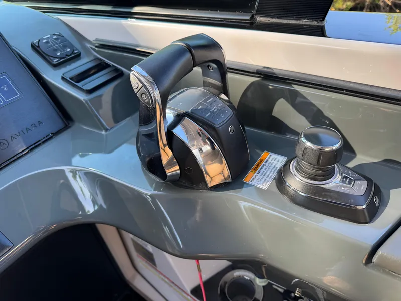 Slide: The Image of Control panel of 2022 Aviara AV36 OB boat, featuring throttle and joystick. - 18