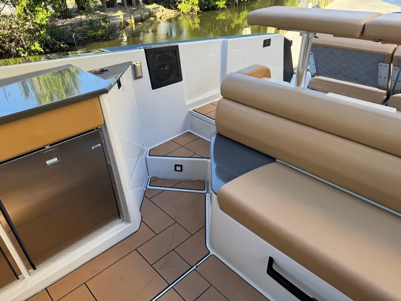 Slide: The Image of 2022 Aviara AV36 OB boat interior with tan seating and kitchenette. - 22