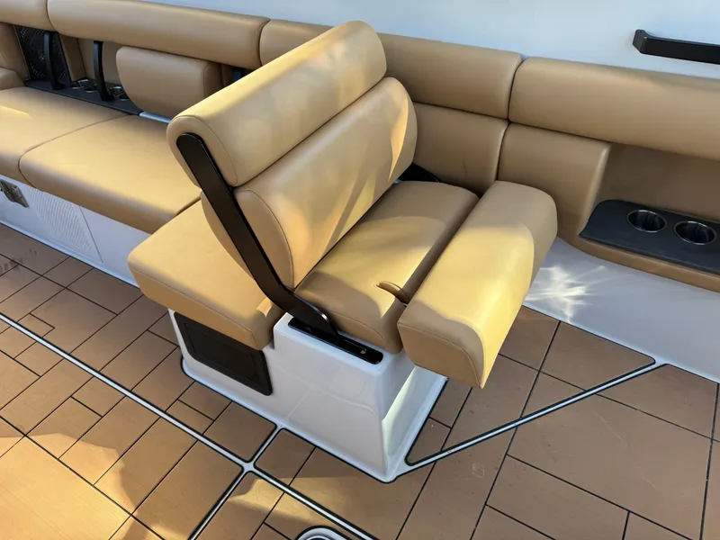 Slide: The Image of Luxurious seating on 2022 Aviara AV36 OB boat with tan upholstery and cup holders. - 25