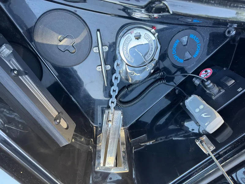 Slide: The Image of Anchor compartment of 2022 Aviara AV36 OB boat with chain and controls. - 34