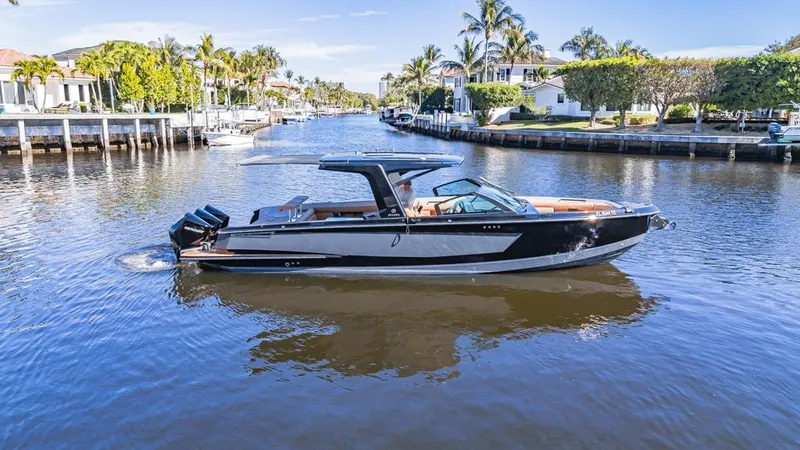 Slide: The Image of 2022 Aviara AV36 OB boat cruising on a scenic canal with palm trees. - 7