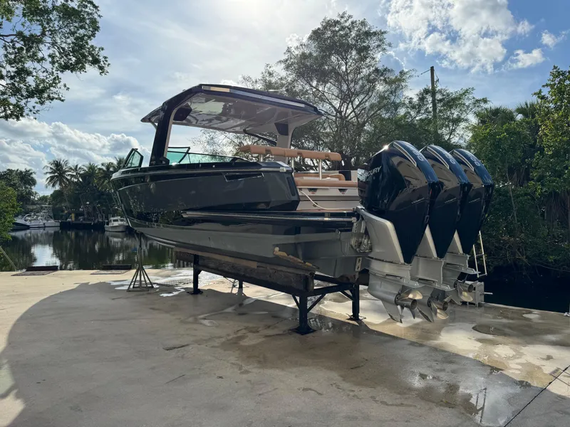 Slide: The Image of 2022 Aviara AV36 OB boat with triple outboard engines on a dock. - 8