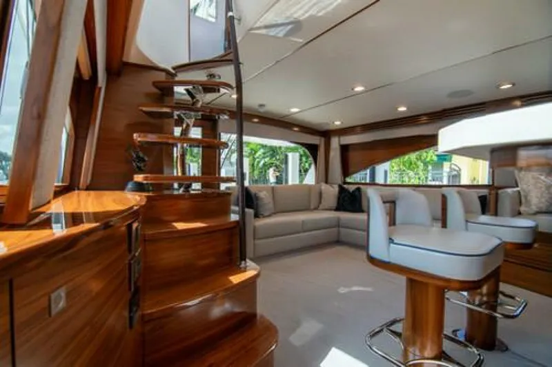 Slide: The Image of Luxurious interior of 2024 Viking 68 Enclosed Bridge yacht with elegant wood finishes. - 10