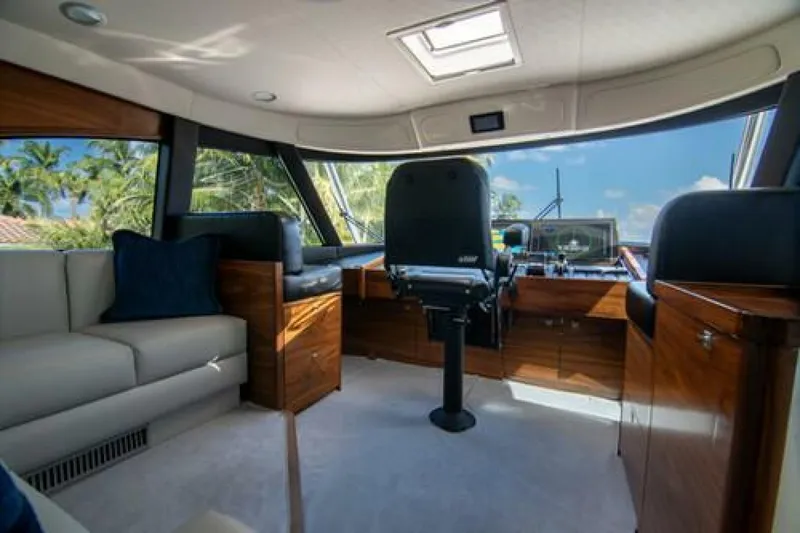 Slide: The Image of Luxurious interior of 2024 Viking 68 Enclosed Bridge yacht with plush seating and modern helm. - 11