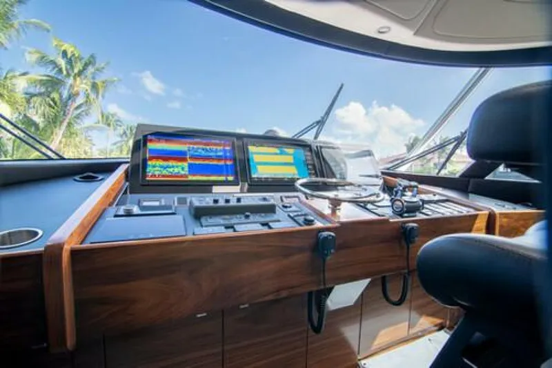 Slide: The Image of 2024 Viking 68 Enclosed Bridge helm with advanced navigation displays and controls. - 12