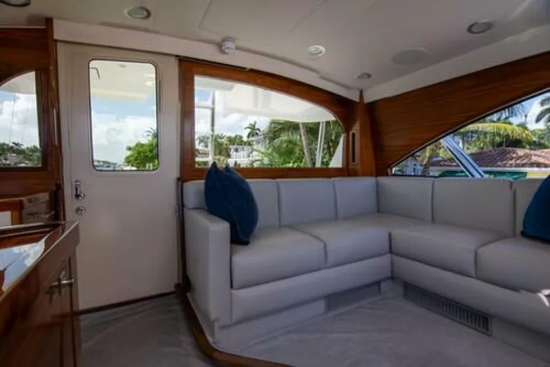 Slide: The Image of Luxurious interior of 2024 Viking 68 Enclosed Bridge yacht with plush seating. - 13
