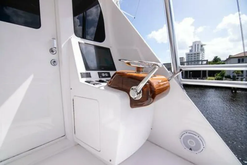 Slide: The Image of 2024 Viking 68 Enclosed Bridge yacht helm with modern controls and waterfront view. - 15