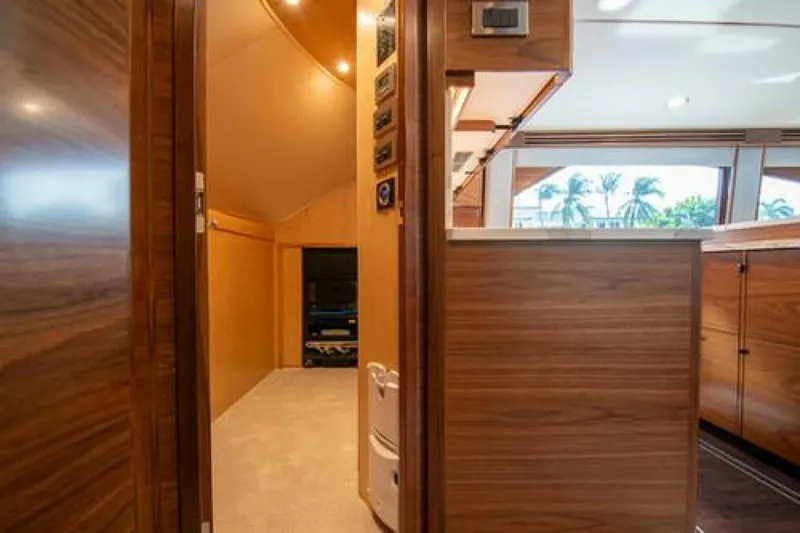 Slide: The Image of Luxurious interior of 2024 Viking 68 Enclosed Bridge yacht with wood paneling and modern design. - 18