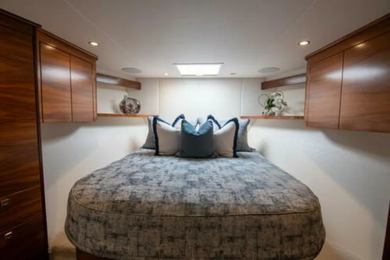 Slide: The Image of Luxurious bedroom interior of 2024 Viking 68 Enclosed Bridge yacht with elegant wood cabinetry. - 19