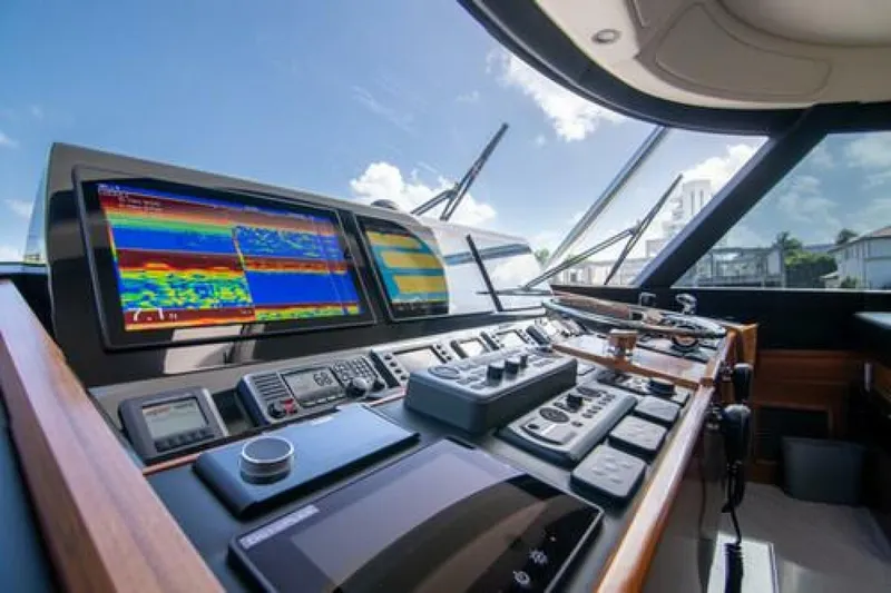 Slide: The Image of 2024 Viking 68 Enclosed Bridge helm with advanced navigation displays and controls. - 2