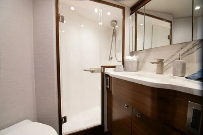 Slide: The Image of Luxurious bathroom in 2024 Viking 68 Enclosed Bridge yacht with modern fixtures and elegant design. - 21