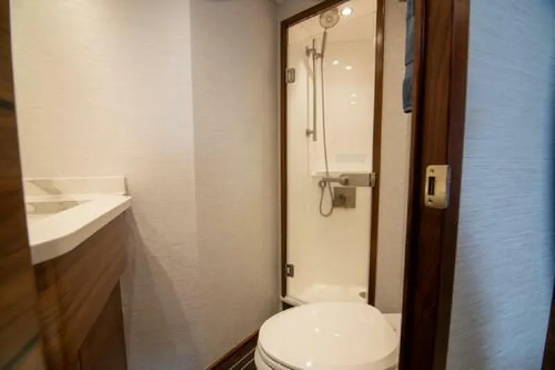 Slide: The Image of Luxurious bathroom in 2024 Viking 68 Enclosed Bridge yacht with modern shower and toilet. - 25