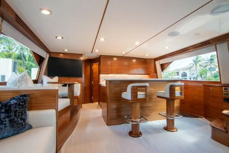 Slide: The Image of Luxurious interior of 2024 Viking 68 Enclosed Bridge yacht with elegant wood finishes. - 3