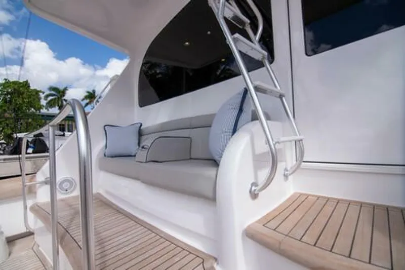 Slide: The Image of 2024 Viking 68 Enclosed Bridge yacht with cushioned seating and sleek design. - 30