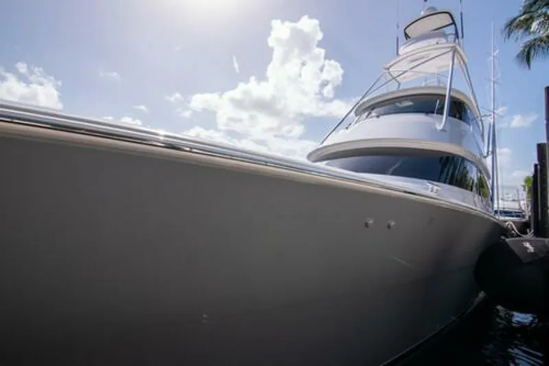 Slide: The Image of 2024 Viking 68 Enclosed Bridge yacht docked under a bright sky. - 36