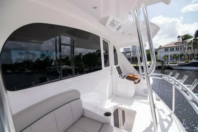 Slide: The Image of 2024 Viking 68 Enclosed Bridge yacht, featuring sleek design and luxurious seating on deck. - 6