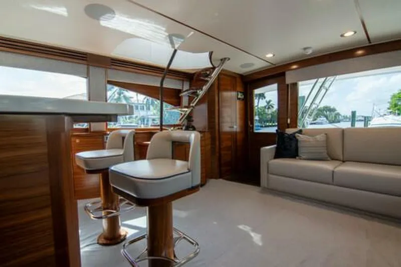 Slide: The Image of Luxurious interior of 2024 Viking 68 Enclosed Bridge yacht with modern seating and elegant design. - 9