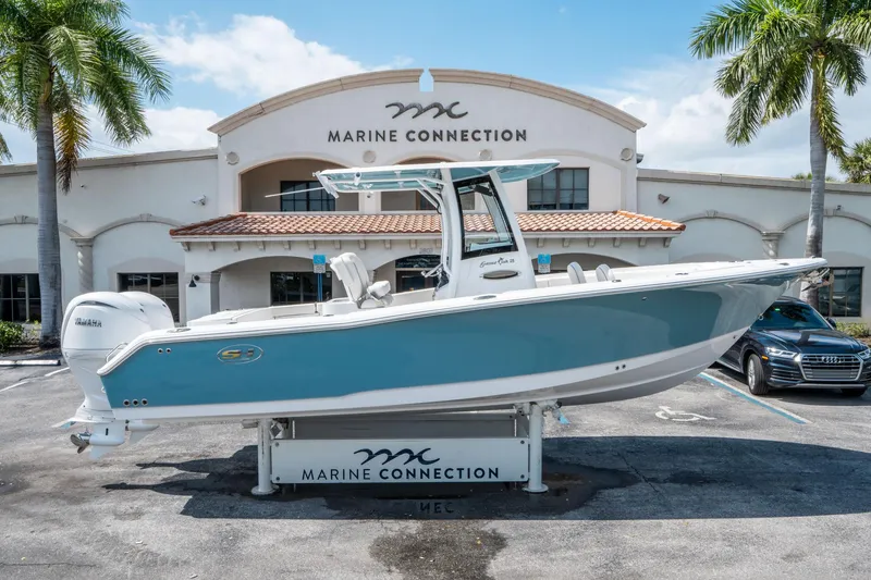 Slide: The Image of 2025 Sea Hunt Gamefish 25 boat displayed at Marine Connection dealership. - 1