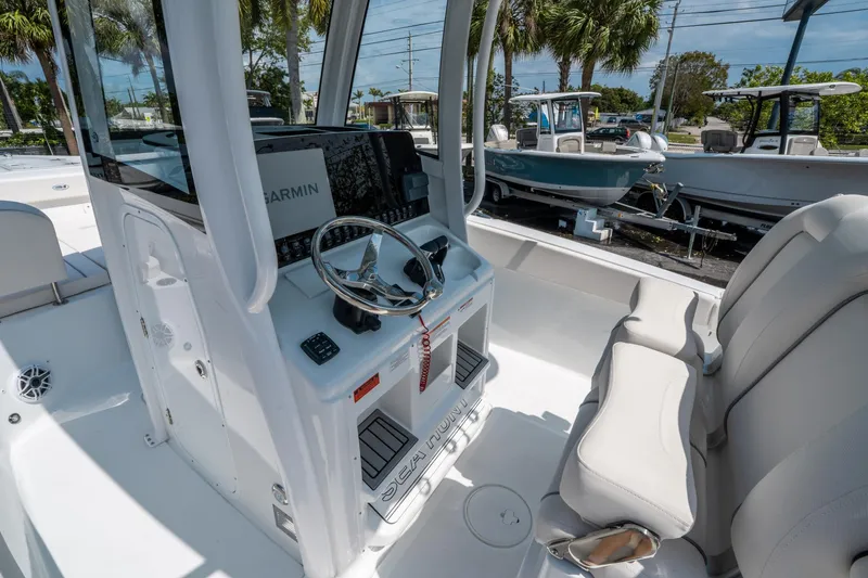 Slide: The Image of 2025 Sea Hunt Gamefish 25 boat interior with steering console and seating. - 20