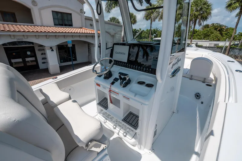 Slide: The Image of 2025 Sea Hunt Gamefish 25 boat interior with steering console and seating. - 21