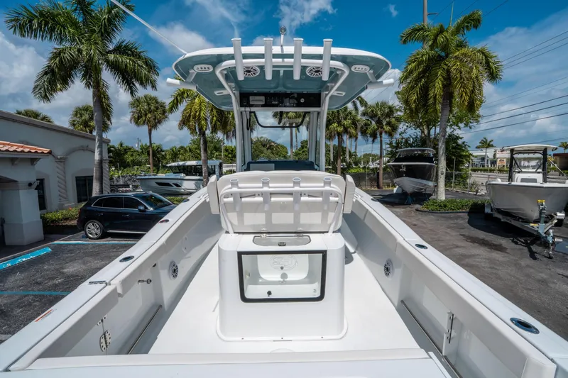 Slide: The Image of 2025 Sea Hunt Gamefish 25 boat, white interior, parked outdoors with palm trees. - 9