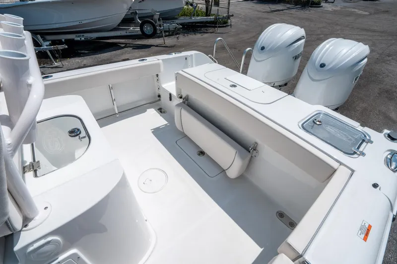 Slide: The Image of 2025 Sea Hunt Gamefish 25 boat interior with dual engines and fishing rod holders. - 12