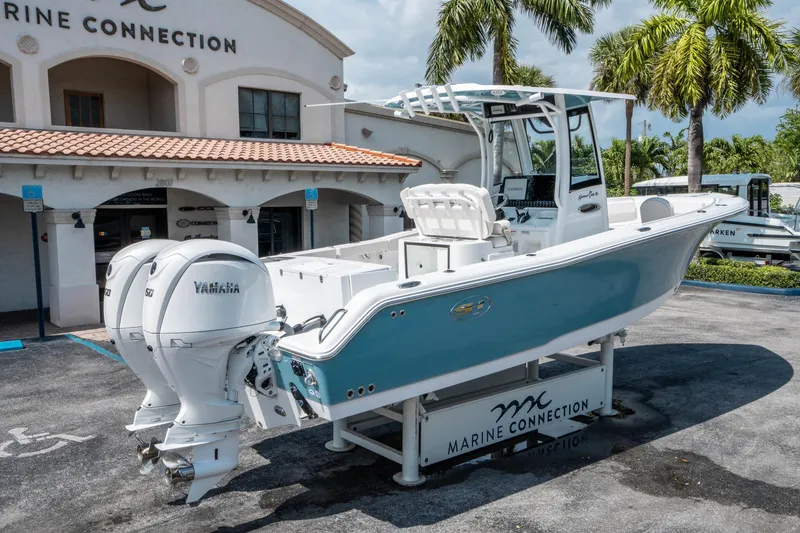 Slide: The Image of 2025 Sea Hunt Gamefish 25 boat with twin Yamaha engines at Marine Connection dealership. - 2