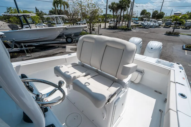 Slide: The Image of 2025 Sea Hunt Gamefish 25 boat interior with dual seating and steering wheel. - 23