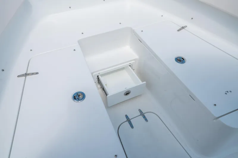 Slide: The Image of 2025 Sea Hunt Gamefish 25 boat storage compartment with open drawer. - 30