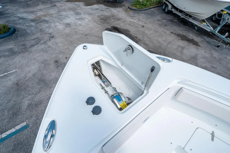 Slide: The Image of 2025 Sea Hunt Gamefish 25 boat with open storage compartment on deck. - 31