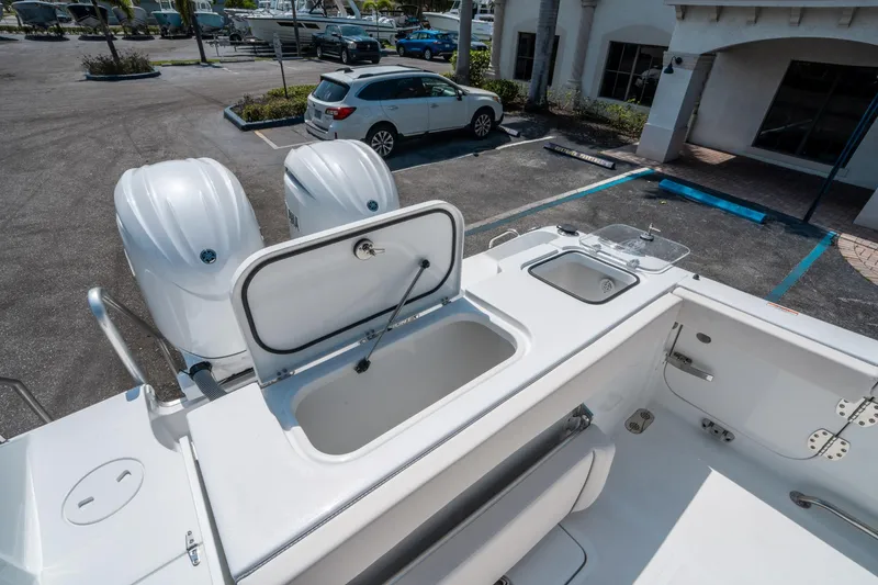 Slide: The Image of 2025 Sea Hunt Gamefish 25 boat with dual engines and open storage compartments. - 14