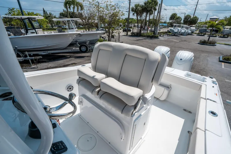 Slide: The Image of 2025 Sea Hunt Gamefish 25 boat interior with helm seating and steering wheel. - 22