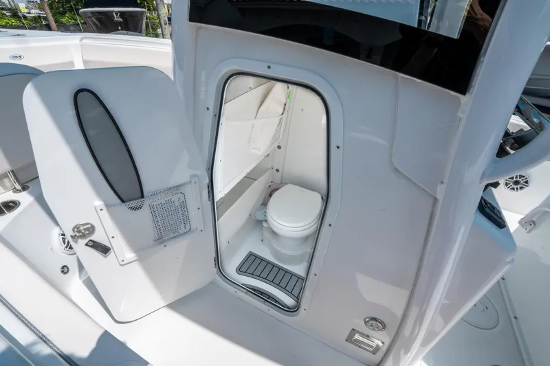Slide: The Image of 2025 Sea Hunt Gamefish 25 boat interior with compact marine toilet. - 24