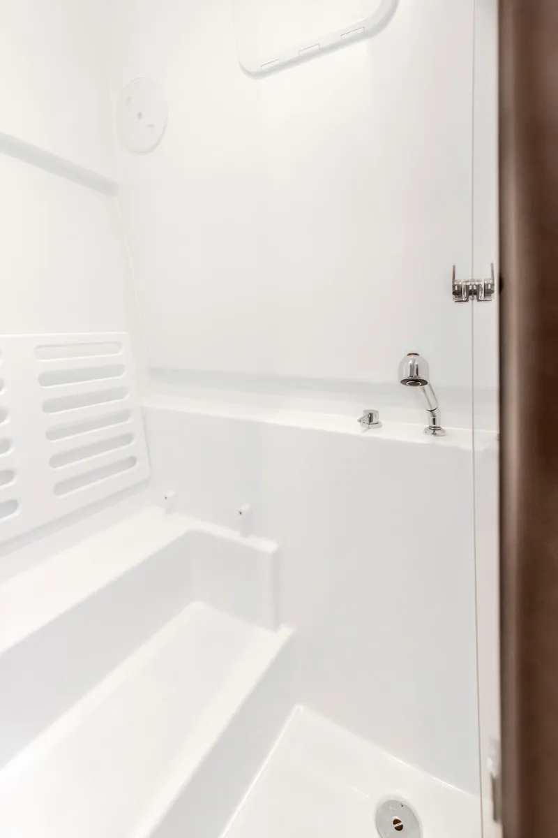 Slide: The Image of Interior shower of 2025 Beneteau 32 Gran Turismo yacht, featuring sleek white design. - 23