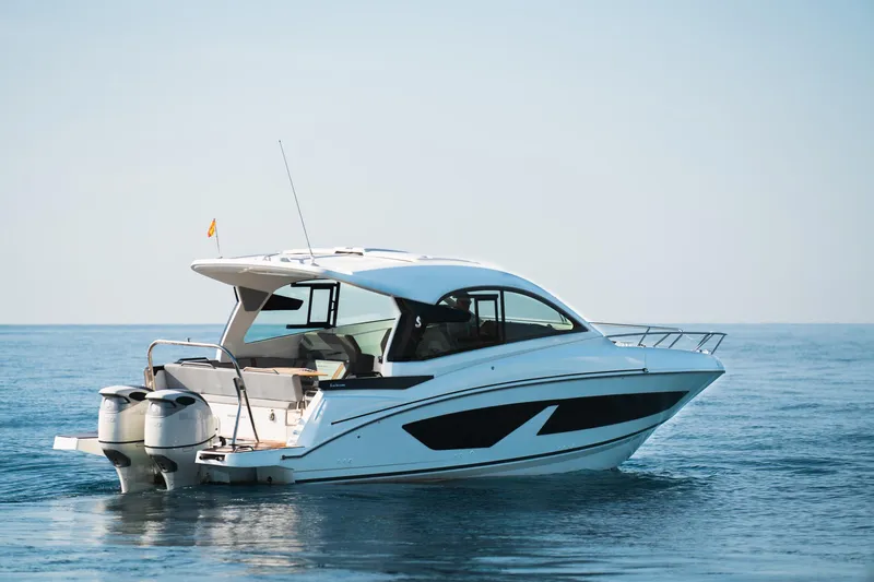 Slide: The Image of 2025 Beneteau 32 Gran Turismo yacht on calm blue water. - 4