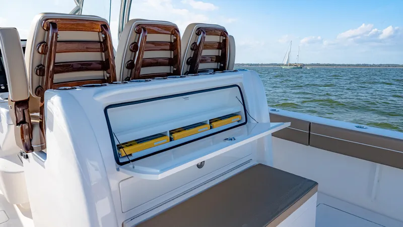 Slide: The Image of 2025 Valhalla Boatworks V-33 interior with seating and storage, on open water. - 18