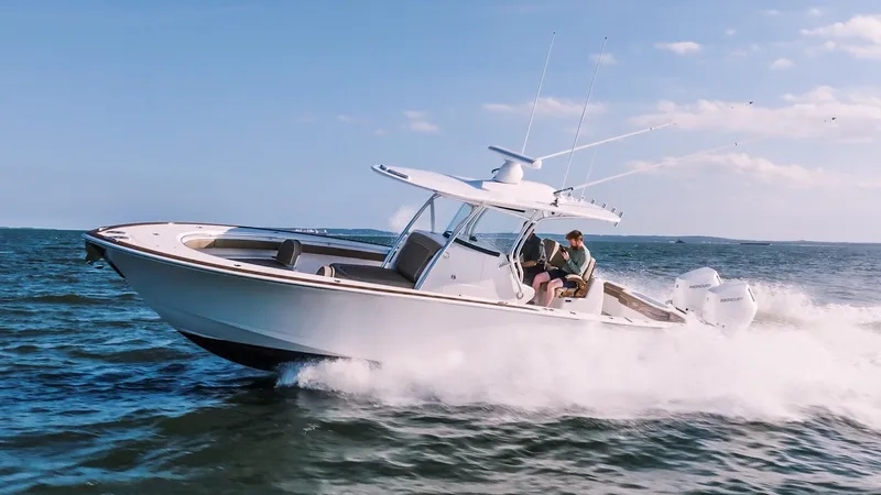 Slide: The Image of 2025 Valhalla Boatworks V-33 cruising on open water under clear skies. - 2