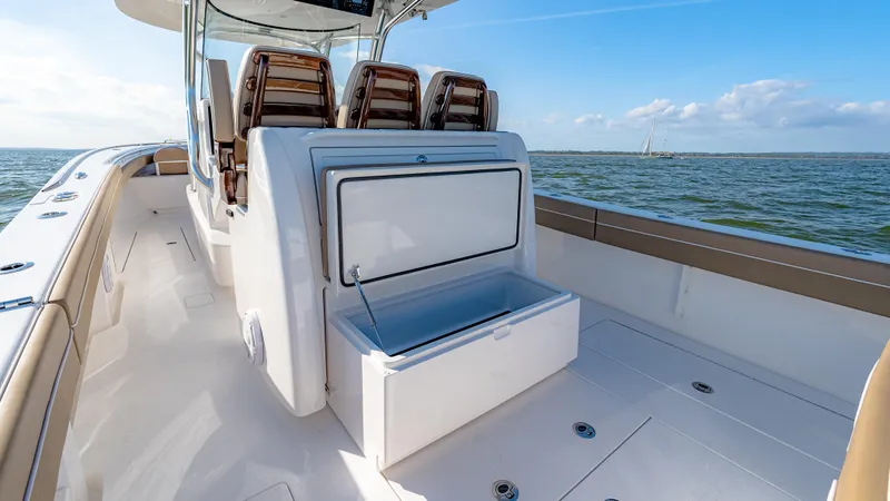 Slide: The Image of 2025 Valhalla Boatworks V-33 deck with open storage compartment, ocean view. - 22