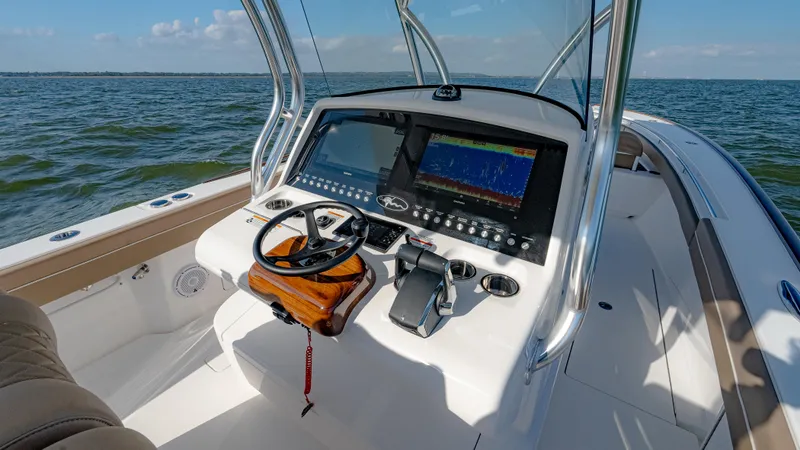 Slide: The Image of 2025 Valhalla Boatworks V-33 helm with advanced navigation system on open water. - 26