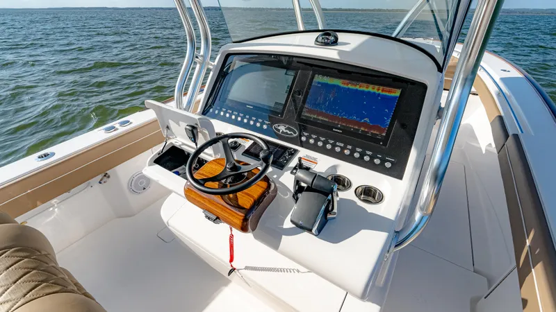 Slide: The Image of 2025 Valhalla Boatworks V-33 helm with advanced navigation system on open water. - 29