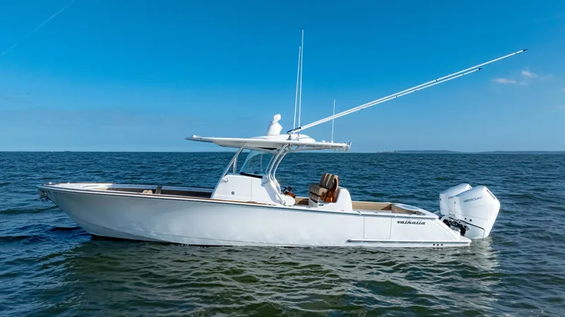 Slide: The Image of 2025 Valhalla Boatworks V-33 on open water, sleek design, clear blue sky. - 3