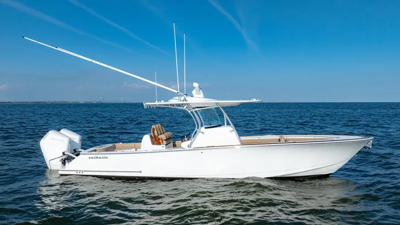 Slide: The Image of 2025 Valhalla Boatworks V-33 cruising on open water under clear blue skies. - 5