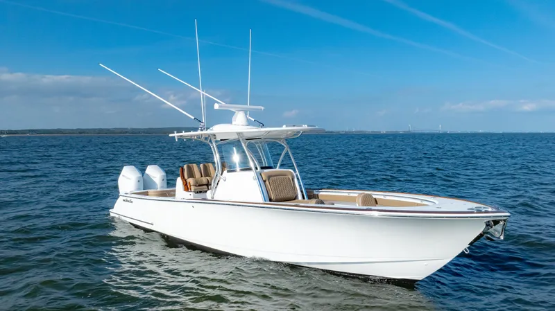 Slide: The Image of 2025 Valhalla Boatworks V-33 cruising on open water under clear blue skies. - 6