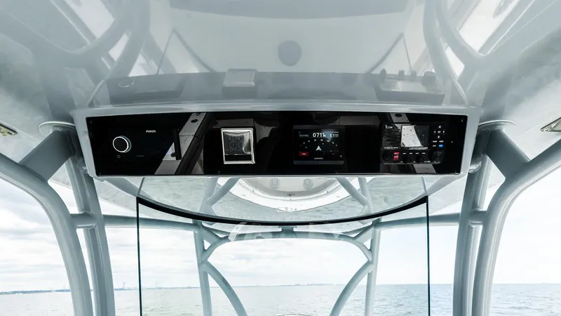 Slide: The Image of 2025 Valhalla Boatworks V-33 helm with advanced navigation controls and ocean view. - 12
