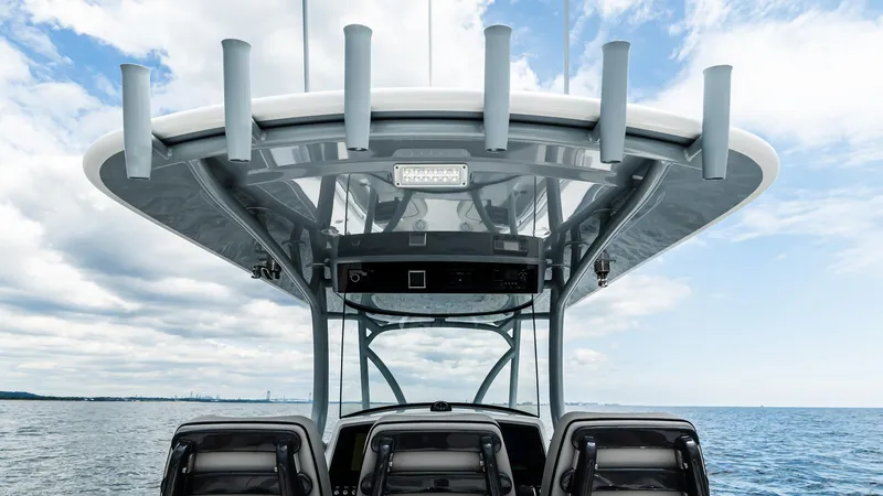Slide: The Image of 2025 Valhalla Boatworks V-33 center console with rod holders on a sunny day. - 13