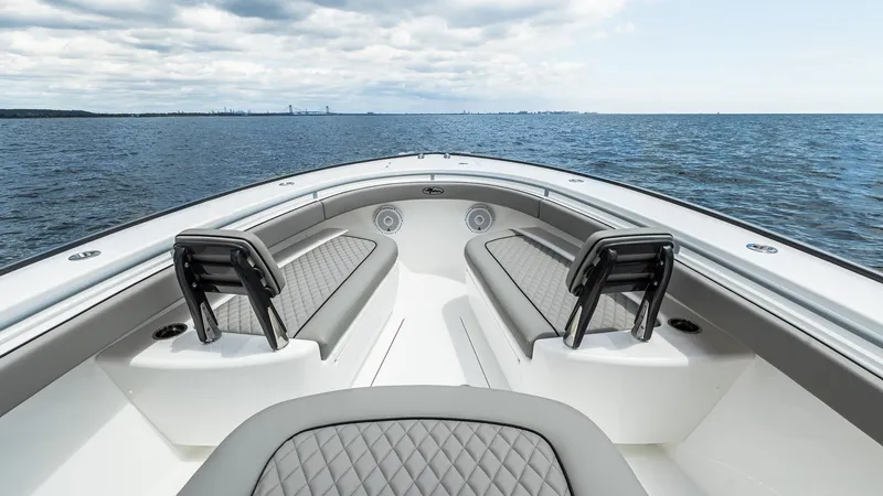 Slide: The Image of 2025 Valhalla Boatworks V-33 bow view with cushioned seating on open water. - 19