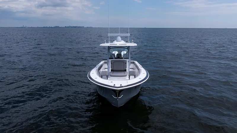Slide: The Image of 2025 Valhalla Boatworks V-33 on open water, front view under cloudy sky. - 5
