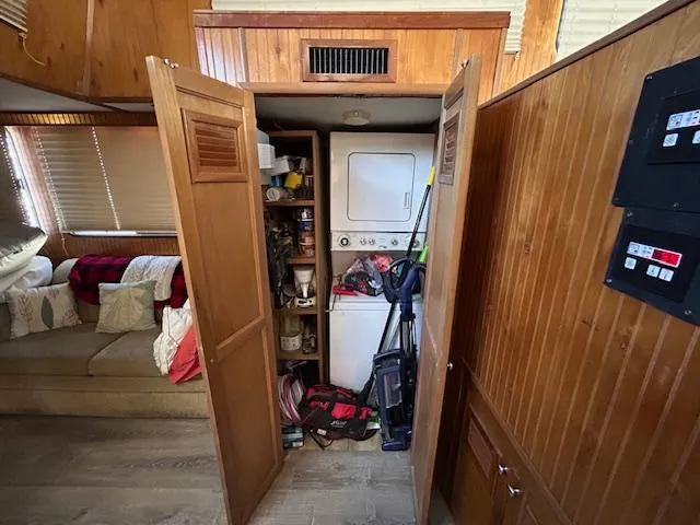 Slide: The Image of Laundry area with stacked washer-dryer in a 1995 Gibson 5500 SERIES boat interior. - 13